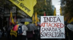 A person holds a sign during a protest outside the Indian Consulate, in Vancouver, on Monday, September 25, 2023. THE CANADIAN PRESS/Darryl Dyck