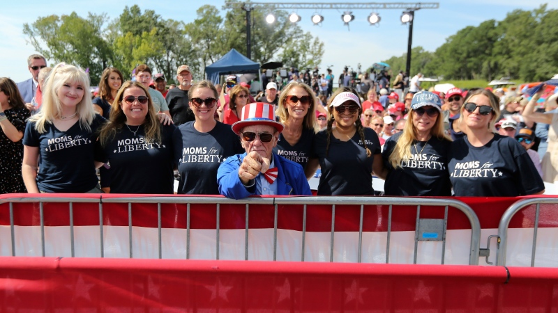 Moms for Liberty members pose for a photo before former President Donald Trump speaks at a rally in Summerville, S.C., Monday, Sept. 25, 2023. (AP Photo/Artie Walker Jr.)