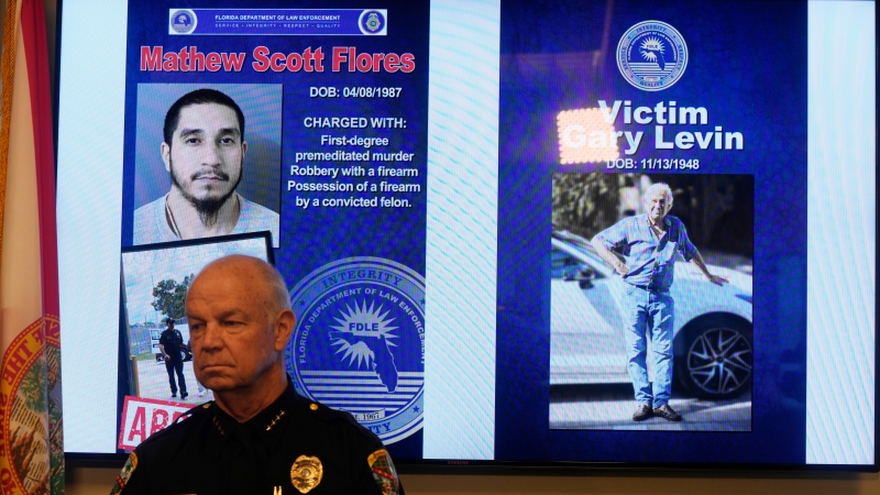 Palm Beach Gardens Chief of Police Clinton Shannon stands near an electric board showing photos of Matthew Flores and Gary Levin during a news conference, Wednesday, Sept. 13, 2023, in Boynton Beach, Fla. (AP Photo/Marta Lavandier, File)