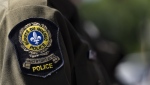 Quebec provincial police have identified the three fishers who died after their boat sank early off of Quebec's Lower North Shore early Monday morning. A Surete du Quebec emblem is seen on an officer’s uniform in Montreal, Tuesday, Aug. 22, 2023. THE CANADIAN PRESS/Christinne Muschi
