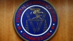 The seal of the Federal Communications Commission (FCC) is seen before an FCC meeting to vote on net neutrality, Dec. 14, 2017, in Washington. Landmark net neutrality rules rescinded under former President Donald Trump could return under a new push by FCC Chairperson Jessica Rosenworcel. The rules would reclassify broadband access as an essential service on par with other utilities like water or power. (AP Photo/Jacquelyn Martin, File)