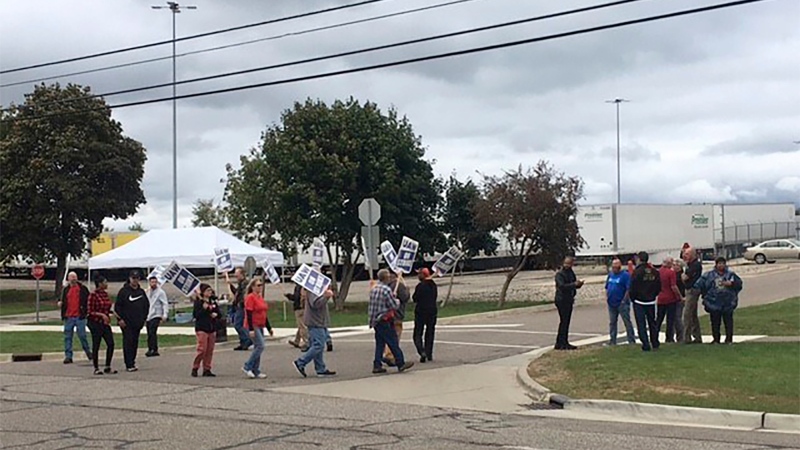 United Auto Workers picket outside the Flint Processing Center where multiple people were hit on Tuesday, Sept. 26, 2023, in Swartz Creek, Mich. (Roberto Acosta/The Flint Journal via AP)

