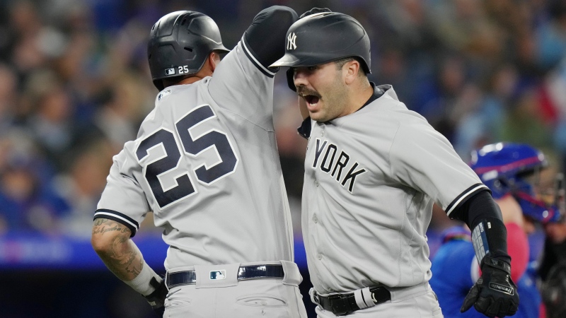 New York Yankees' Austin Wells (right) celebrates with teammate Gleyber Torres after hitting a two run home run off Toronto Blue Jays relief pitcher Jordan Romano during ninth inning American League MLB baseball action in Toronto on Tuesday, September 26, 2023. THE CANADIAN PRESS/Chris Young