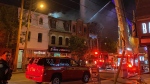 Firefighters are on the scene of a four-alarm blaze at a cluster of buildings on Queen Street West, west of Bathurst Street. (Mike Nguyen/ CP24)