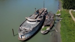 The retired BC Ferries vessel Queen of Sidney, left, that was in operation from 1960 to 2000, and another derelict vessel are seen moored on the Fraser River, in Mission, B.C., on Tuesday, July 18, 2023. (THE CANADIAN PRESS/Darryl Dyck)