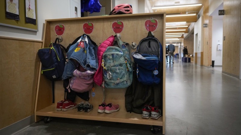 Backpacks, jackets and shoes belonging to students are seen outside an elementary school classroom in Vancouver, B.C., Thursday, April 13, 2023. THE CANADIAN PRESS/Darryl Dyck