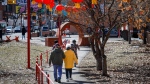 Pedestrians stroll through Chinatown in downtown Calgary, Alta., Friday, April 14, 2023.THE CANADIAN PRESS/Jeff McIntosh