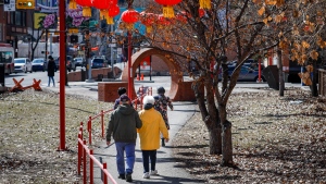 Pedestrians stroll through Chinatown in downtown Calgary, Alta., Friday, April 14, 2023.THE CANADIAN PRESS/Jeff McIntosh