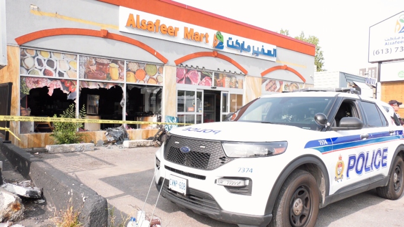 A police car is parked out front of the damaged Alsafeer Mart on Bank St. south of Heron Rd. in Ottawa after an early morning fire on September 27, 2023.. 