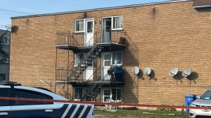 Police tape surrounds an apartment building in Longueuil where police say the bodies of two women were found on Wednesday, Sept. 27, 2023. (Stephane Giroux/CTV News)