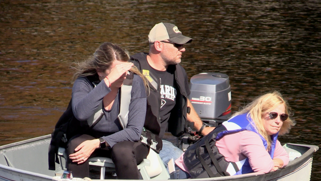 Kirk Dillon’s sister Krystle, brother-in-law Matt Read and mother Kathie search for the missing man on a boat at Bert Minett Boat Launch in Bracebridge, Ont., on Wed., Sept. 27, 2023. (CTV News/Mike Arsalides)