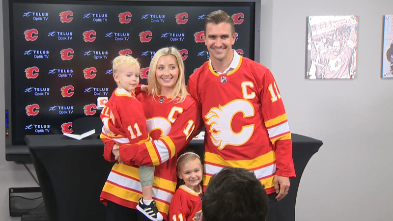 Mikael Backlund stands with his wife Frida, daughter Tilly and son Oliver after being announced as the Calgary Flames new captain on Sept. 27, 2023. 