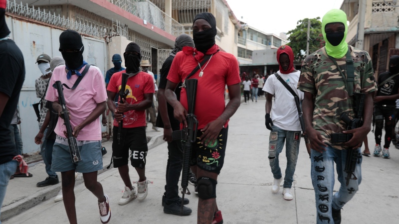 Armed members of "G9 and Family" march in a protest against Haitian Prime Minister Ariel Henry in Port-au-Prince, Haiti, Sept. 19, 2023. (AP Photo/Odelyn Joseph)