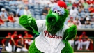FILE - In this Feb. 25, 2020, file photo, The Phillie Phanatic mascot performs before a spring training baseball game against the Toronto Blue Jays in Clearwater, Fla. (AP Photo/Frank Franklin II, File)