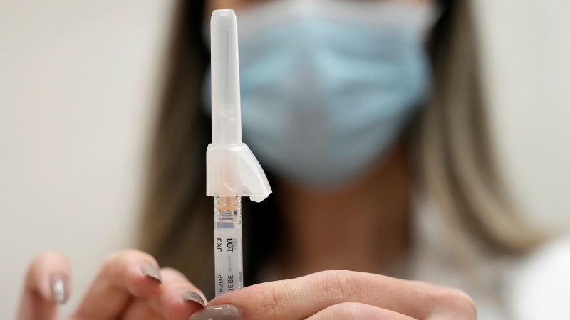 Pharmacist Kim Nguyen prepares to administer a COVID-19 vaccine. (Melissa Phillip/Houston Chronicle via AP)