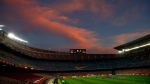 A general view of the the Camp Nou stadium as the sun sets ahead of the Spanish La Liga soccer match between FC Barcelona and Valladolid CF in Barcelona, Spain, on April 5, 2021. Spanish police raided offices of the Spanish soccer federation on Thursday Sept. 28, 2023 as part of a judicial investigation into the alleged payment of millions of euros over several years by Barcelona soccer club to the vice president of Spain’s football refereeing committee. (AP Photo/Joan Monfort, File)