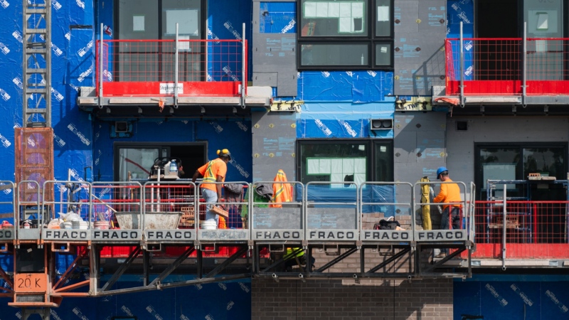 Construction workers are seen at the site of an affordable housing project in the Thornecliffe Park region of Ottawa, Sept. 28, 2023. THE CANADIAN PRESS/Spencer Colby