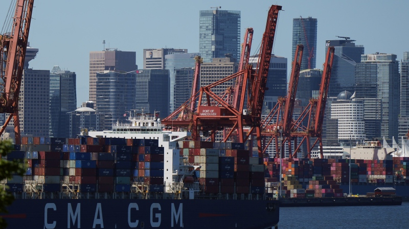 Gantry cranes sit idle as a container ship is docked at port during a work stoppage, in Vancouver, on Wednesday, July 19, 2023. THE CANADIAN PRESS/Darryl Dyck