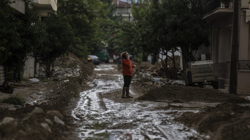 A woman stands in a street of the storm-hit city of Volos, Greece, where power and water outages remained in some districts, on Friday, Sept. 29, 2023. Bad weather has eased in central Greece leaving widespread flooding and infrastructure damage across the farming region that has been battered by two powerful storms in less than a month. (AP Photo/Petros Giannakouris)