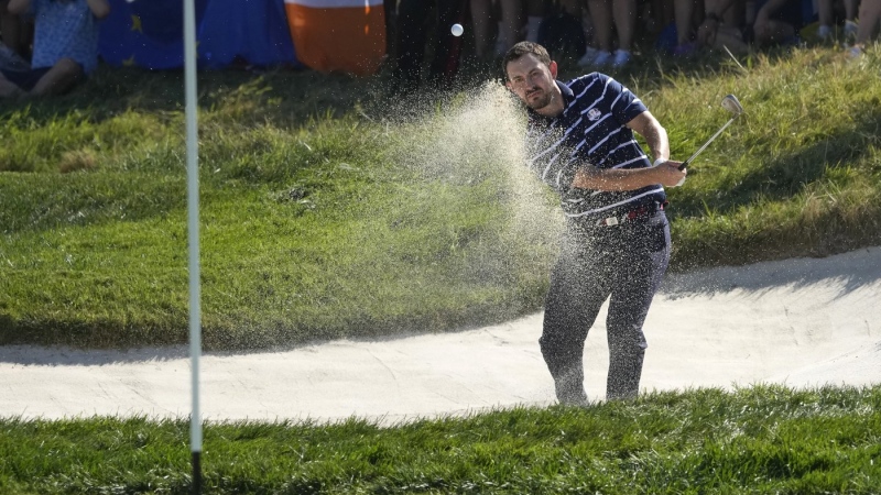 United States' Patrick Cantlay chips out of a bunker on the 16th green during his morning Foursome match at the Ryder Cup golf tournament at the Marco Simone Golf Club in Guidonia Montecelio, Italy, Friday, Sept. 29, 2023. (AP Photo/Andrew Medichini)