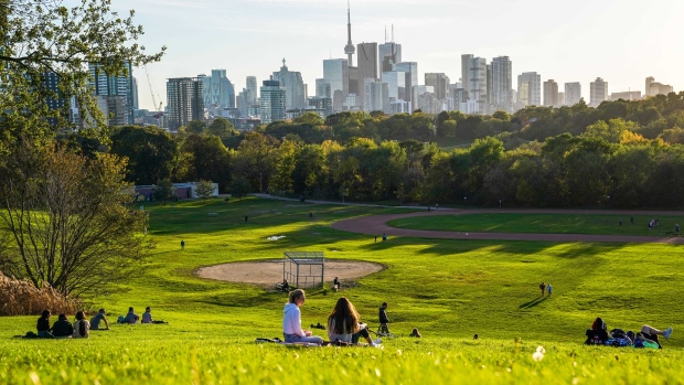 People watch late day sunshine from Riverdale Park East in Toronto on Tuesday, October 19, 2021. THE CANADIAN PRESS/Evan Buhler 