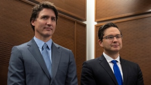 Prime Minister Justin Trudeau stands with Conservative leader Pierre Poilievre as he waits to speak at a Tamil heritage month reception, Monday, Jan. 30, 2023 in Ottawa. THE CANADIAN PRESS/Adrian Wyld