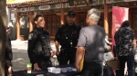 Montreal police speak with a man at the Mid-Autumn Festival in Chinatown on Friday, Sept. 29, 2023. (CTV News)