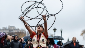 Hoop dancer Alya Bull performs during the opening of a new reconciliation garden to honour residential school survivors in Edmonton on Friday September 29, 2023. THE CANADIAN PRESS/Jason Franson.