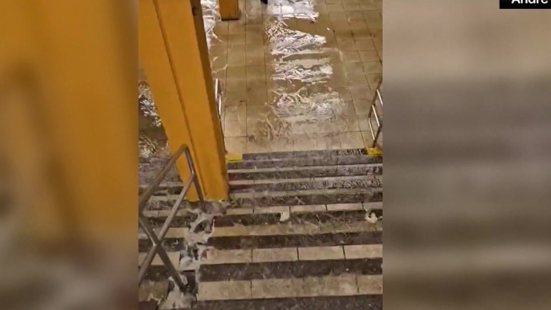 Water rushes down NYC subway station