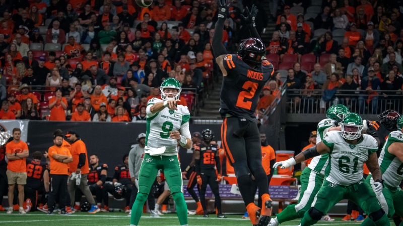 BC Lions Josh Woods (2) tries to block pass by Saskatchewan Roughriders quarterback Jake Dolegala (9) during first half of CFL football action in Vancouver, B.C., Friday, Sept. 29, 2023. THE CANADIAN PRESS/Ethan Cairns 