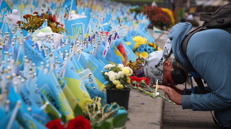 A woman reacts during the All-National minute of silence in commemoration of Ukrainian soldiers killed in the country's war against Russia on Independence square in Kyiv, Ukraine, Sunday, Oct. 1, 2023. Ukraine commemorates veterans and fallen soldiers on Sunday. The date of the annual Day of the Defenders was moved from 14th October as part of the reforms of the church calendar introduced by President Volodymyr Zelenskyy. (AP Photo/Alex Babenko)
