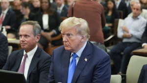 Former President Donald Trump, right, sits in the courtroom at New York Supreme Court, Monday, Oct. 2, 2023, in New York. Trump is making a rare, voluntary trip to court in New York for the start of a civil trial in a lawsuit that already has resulted in a judge ruling that he committed fraud in his business dealings. (AP Photo/Seth Wenig)