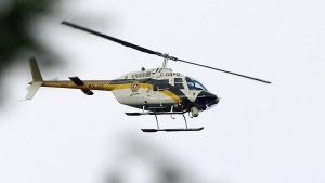 A Surete du Quebec helicopter searches the Kitigan-Zibi reserve south of Maniwaki, Que., Wednesday April 30, 2008. THE CANADIAN PRESS/Sean Kilpatrick
