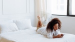 A woman sitting on her bed scrolling through her phone. Many people don't even realize they're addicted to the internet, a new study says. (Photo by Thirdman/Pexels)