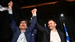 Parti Quebecois candidate Pascal Paradis, left, raises his hands with PQ Leader Paul St-Pierre Plamondon as he arrives to speak to supporters after being announced the winner in the Jean-Talon byelection, in Quebec City, Monday, Oct. 2, 2023. THE CANADIAN PRESS/Jacques Boissinot