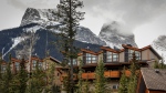 The Three Sisters loom over homes in Canmore, Alta., Monday, April 24, 2023. THE CANADIAN PRESS/Jeff McIntosh