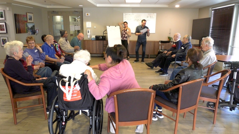 People living with Alzheimer's participate in a program at Club 36 called 'time slips', where they look at pictures and make up a story about what they see.