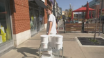 A staff member unloads tubs of ice cream at Four All Ice Cream in Waterloo on Oct. 3, 2023 amid unseasonably warm temperatures. The business says normally at this time of year, it would be reducing its hours. (Sijia Liu/CTV Kitchener)