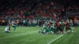 BC Lions defensive lineman Nick Usher (99) tries to block Saskatchewan Roughriders kicker Brett Lauther (12) kick during second half of CFL football action in Vancouver, B.C., Friday, Sept. 29, 2023. THE CANADIAN PRESS/Ethan Cairns