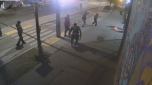 One of the suspects can be seen spraying something at the victim in this still from a video posted on the Victoria Police Department website. (vicpd.ca)