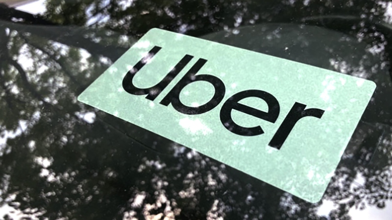 An Uber sign is displayed inside a car in Palatine, Ill., Monday, May 22, 2023. (AP Photo/Nam Y. Huh)