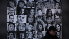 Photographs of victims of Flight PS752 are seen as thousands of people attend a rally in North Vancouver, B.C., on Sunday, Jan. 8, 2023.  THE CANADIAN PRESS/Darryl Dyck