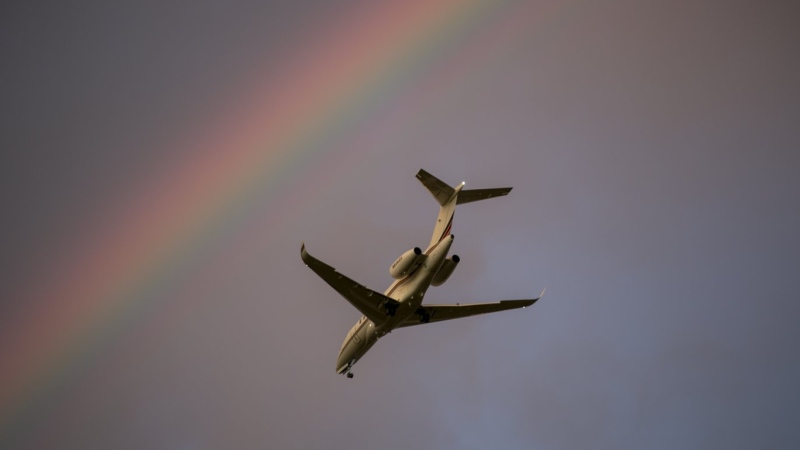 A plane that took off from Teterboro Airport passes by a rainbow in the sky over Rutherford, New Jersey, on Monday, September 18, 2023. (AP Photo/Ted Shaffrey)