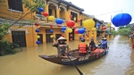 People ride a boat in flooded street in Hoi An, Vietnam, Monday, Nov. 6, 2017. (AP Photo/Hau Dinh)