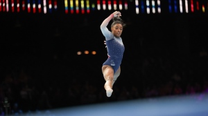 United States' Simone Biles competes on the floor during the women's team final at the Artistic Gymnastics World Championships in Antwerp, Belgium, Wednesday, Oct. 4, 2023. (AP Photo/Geert vanden Wijngaert)