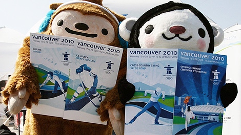 Vancouver 2010 Winter Olympic Games mascots Quatchi, left, and Miga hold mock ups of what the Olympic tickets will look like following a news conference in Vancouver, B.C., on Thursday June 4, 2009. VANOC will release the final 150,000 available tickets for sale to the public June 6. (CP/Darryl Dyck)