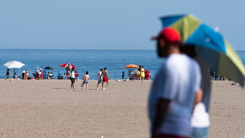 People take in the warm weather at Woodbine Beach Park in Toronto, on Tuesday, Aug. 22, 2023. THE CANADIAN PRESS/Spencer Colby