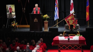 Ridge Meadows RCMP Chaplain Greg Dalman speaks as RCMP Const. Rick O'Brien's stetson rests on his casket during a regimental funeral in Langley, B.C., on Wednesday, "Oct. 4, 2023. THE CANADIAN PRESS/Darryl Dyck