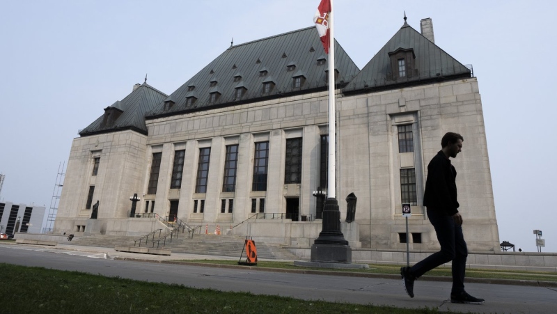 A man walks past the Supreme Court of Canada, Friday, June 16, 2023, in Ottawa. THE CANADIAN PRESS/Adrian Wyld
