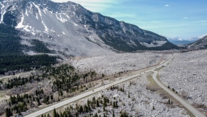 Traffic travels along Highway 3 through the remains of the Frank Slide in the Crowsnest Pass near Blairmore, Alta., Wednesday, May 3, 2023. THE CANADIAN PRESS/Jeff McIntosh